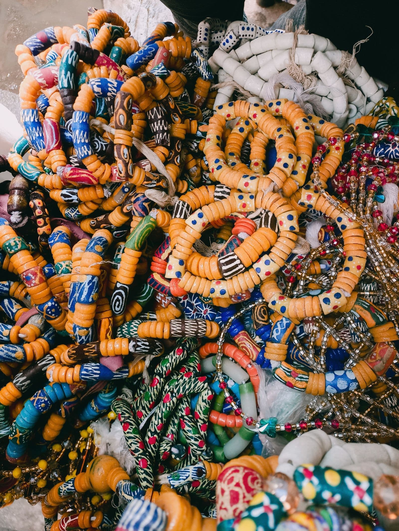 Hand-painted Krobo glass beads strung into necklaces and bracelets